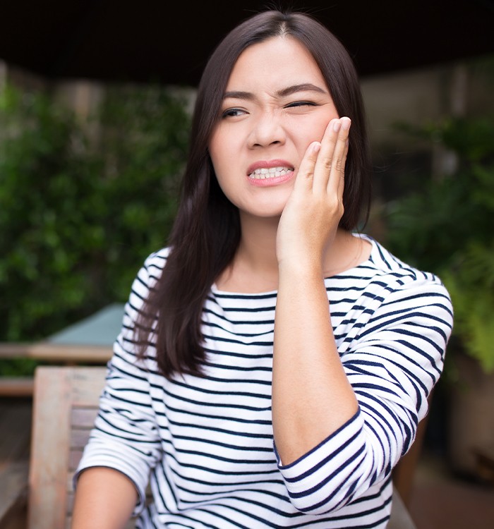 Woman holding jaw in pain