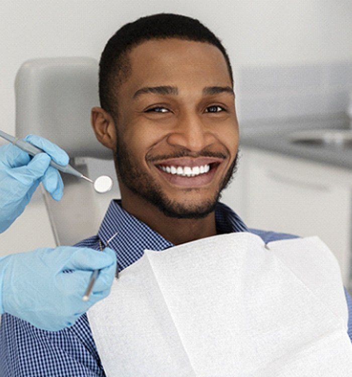 A young man smiling in preparation for his regular dental checkup in Trumbull