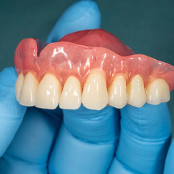 hand holding full denture