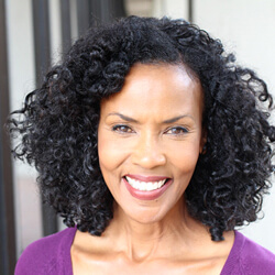 smiling woman in purple blouse