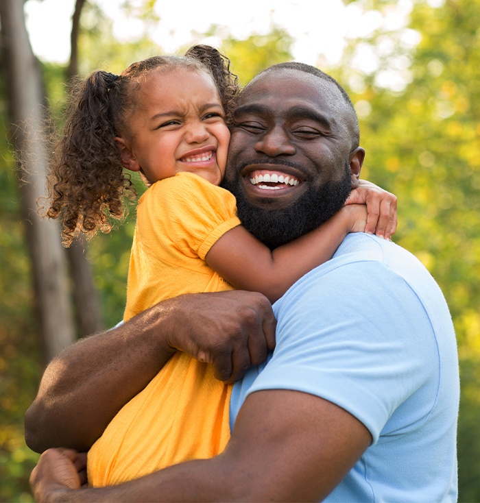 Father and daughter with healthy smiles