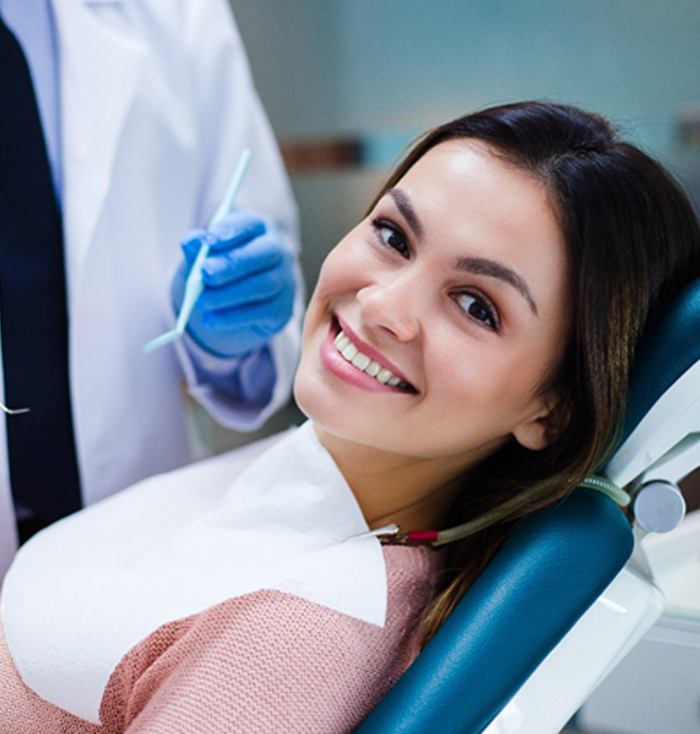 Happy female patient attending dental cleaning and checkup