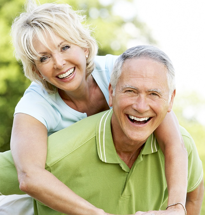 Smiling man and woman outdoors