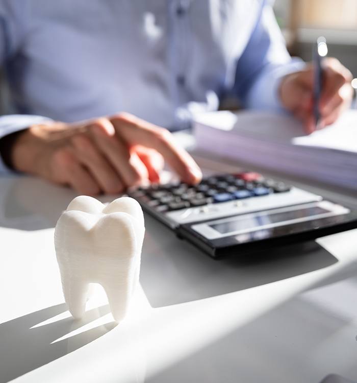 Patient calculating the cost of dental care and dental insurance coverage