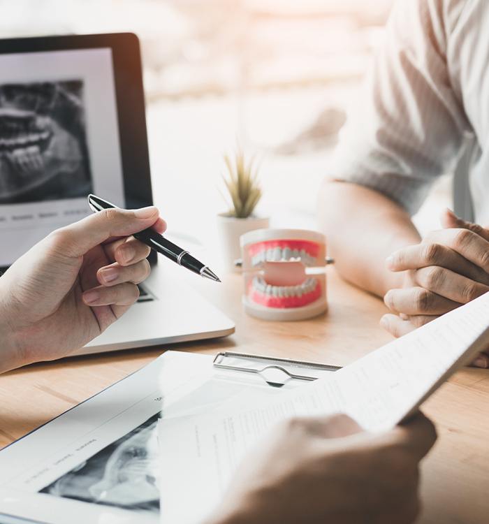 Dentist and patient talking at desk