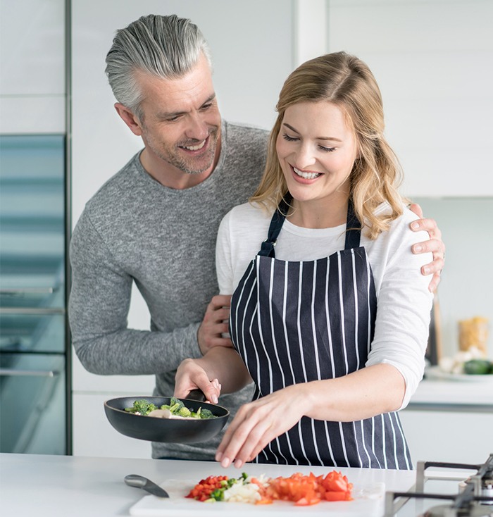 Man and woman cooking a meal