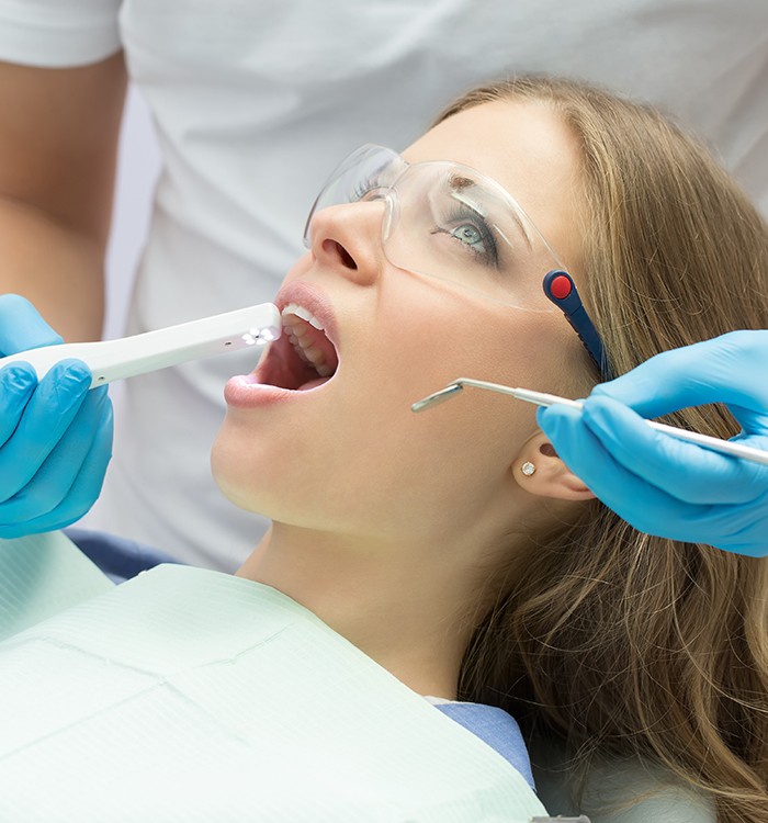Dentist using intraoral camera to capture images of smile
