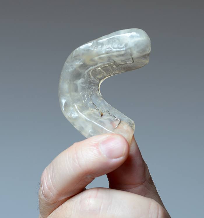 Hand holding an occlusal splint