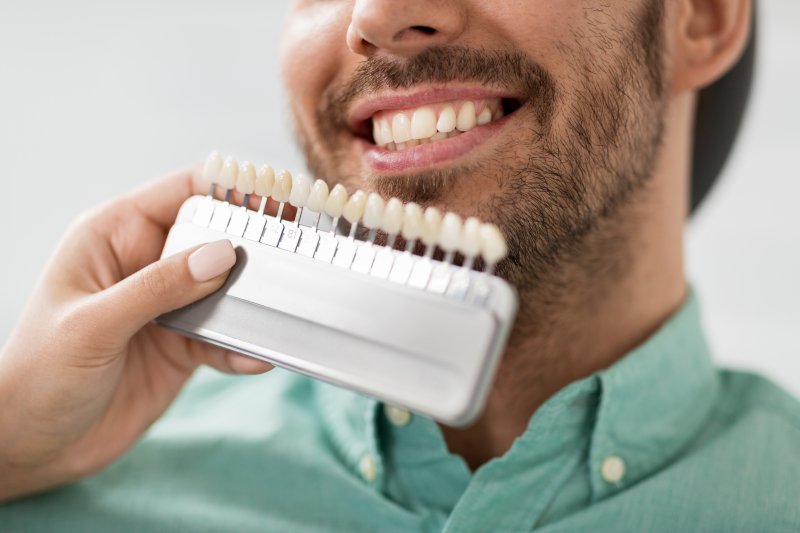 man smiling while getting veneers in Trumbull